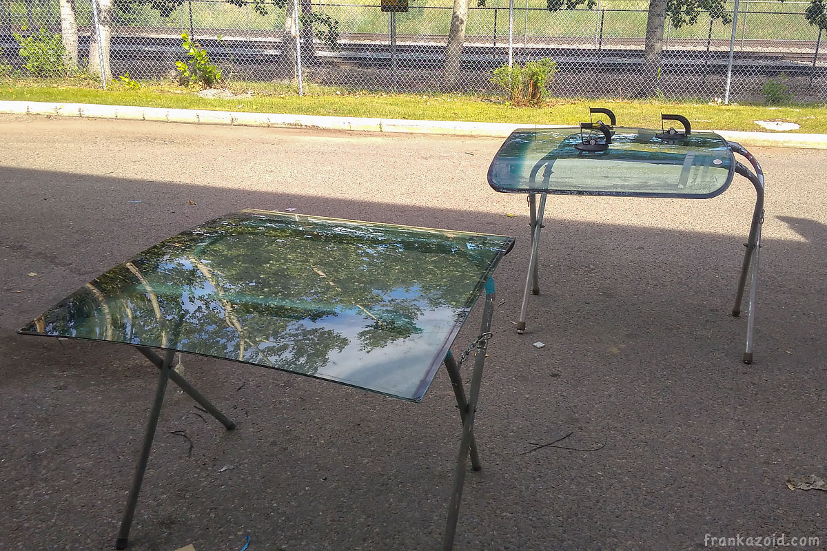 Windshields laying on two stands